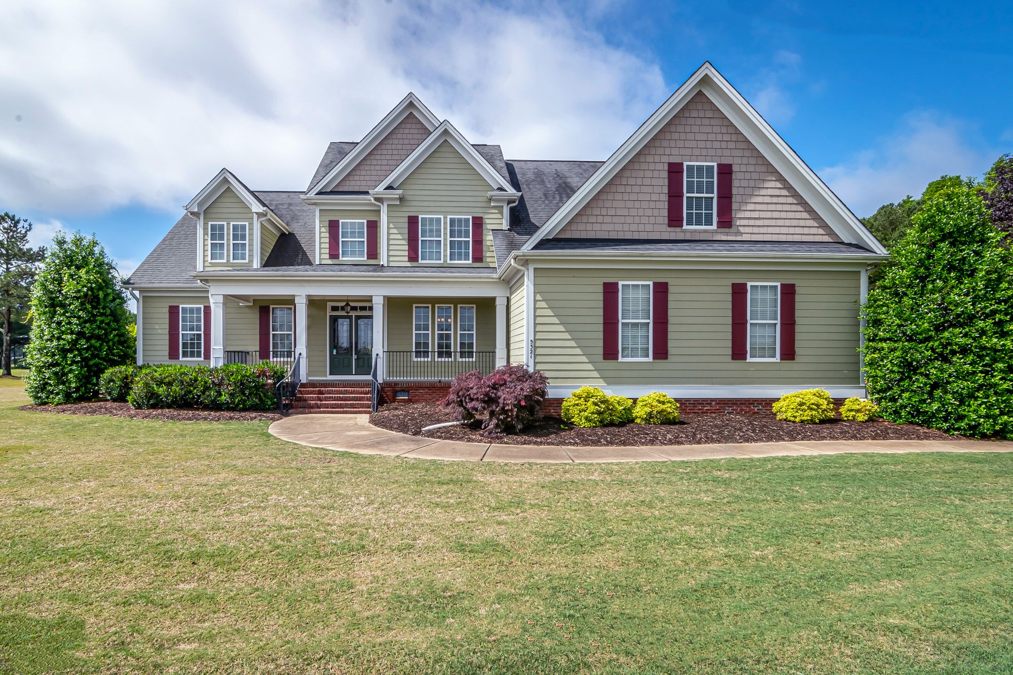 A welcoming suburban home with a landscaped front yard